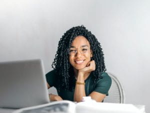Image of a women sitting at a laptop